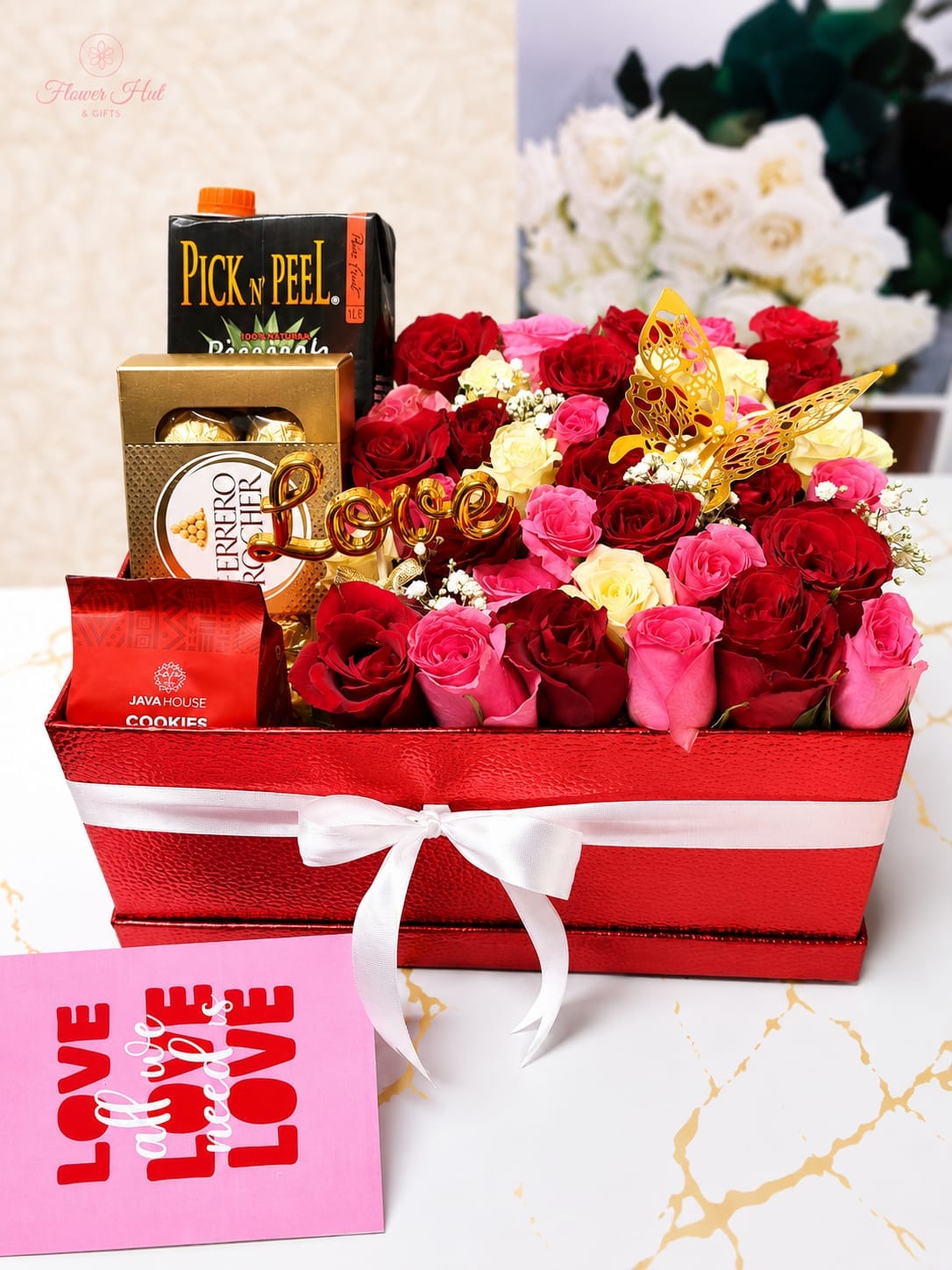 Surprise gift for my gilrfiend gift box containing roses, java house biscuits, Ferrero chocolate, pick n peel pineapple juice
