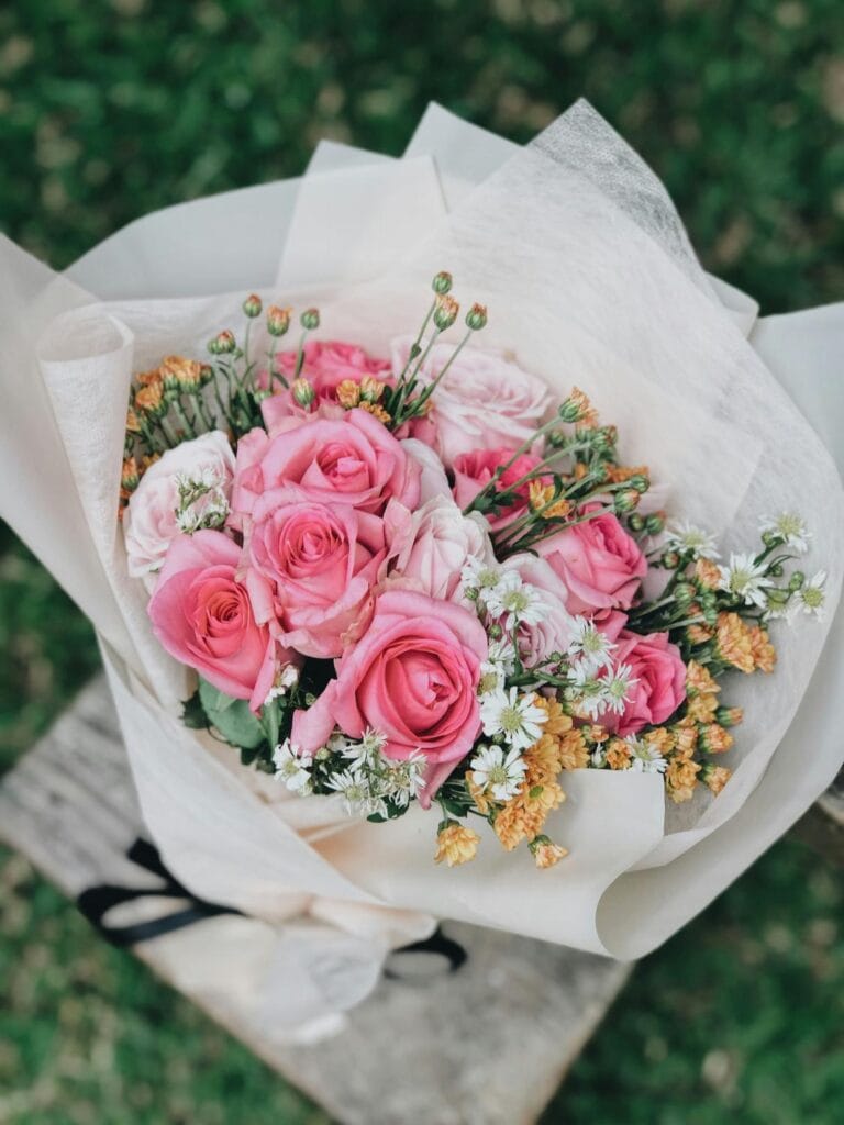 Pink roses wrapped in white paper